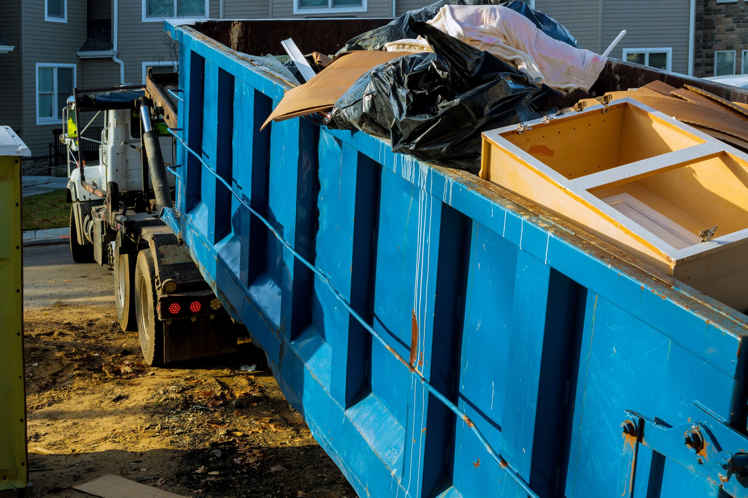 dumpster, recycle waste and garbage bins near new construction site of appartment houses building