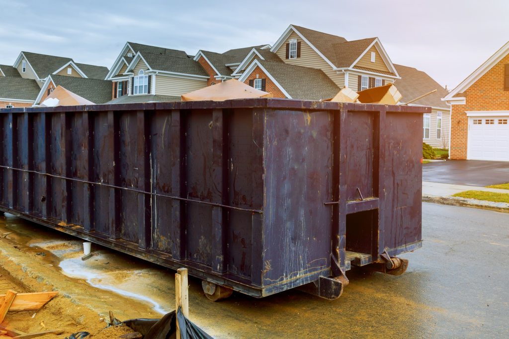 garbage containers near the new home, red containers, recycling and waste construction site on the background